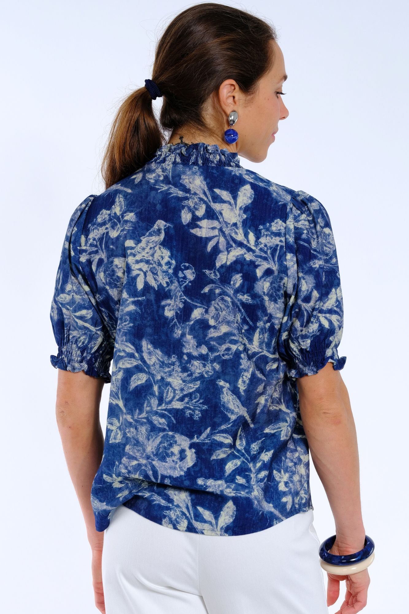 Blue floral V-neck blouse for women with short sleeves and ruffle neck